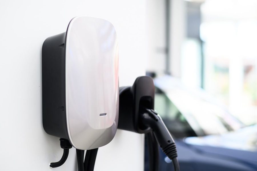 Electric vehicle charger installed on wall of a home